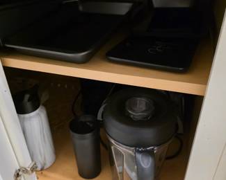 High-speed blender with tall pitcher, sheet pans and black serving tray