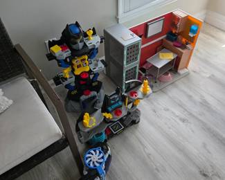 Kids' toy lot with superhero tower playset and dollhouse room set