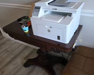 HP laser printer on Regency-style pedestal card table with flower pot