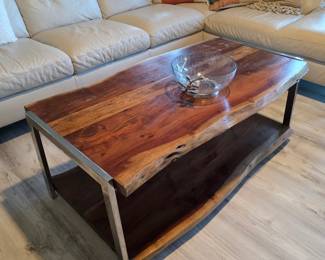 Live-edge wood coffee table with brushed steel frame and glass bowl