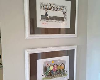 Pair of white-framed whimsical prints of women at table and on bench