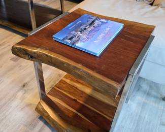 Live-edge wood end table with brushed steel sled legs and lower shelf