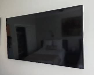 Large wall-mounted flat-screen television with slim silver bezel