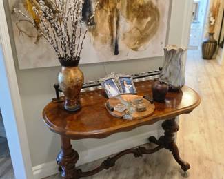 Victorian-style burl walnut console with carved trestle base and vases