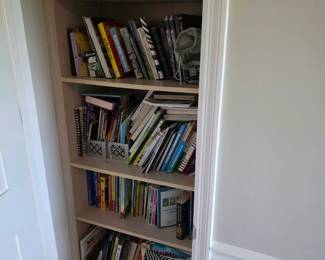 Cookbooks, paperbacks and hardcover books with wire storage baskets