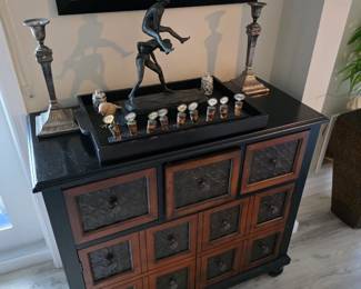 Black lacquer basketweave-front chest with bronze-tone figure sculpture