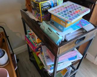Rustic wood and metal rolling cart with kids' craft kits and play sand