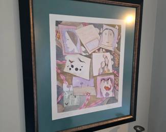 Framed pastel collage-style print of stylized faces, cat and dog, teal mat