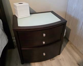 Espresso bow-front three-drawer nightstand with frosted glass top