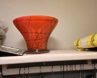 Orange-red art glass flared vase with black swirled line decoration