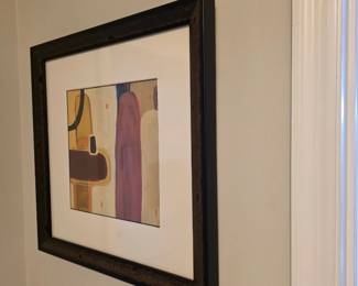 Framed abstract print with rounded forms in plum, ochre and black