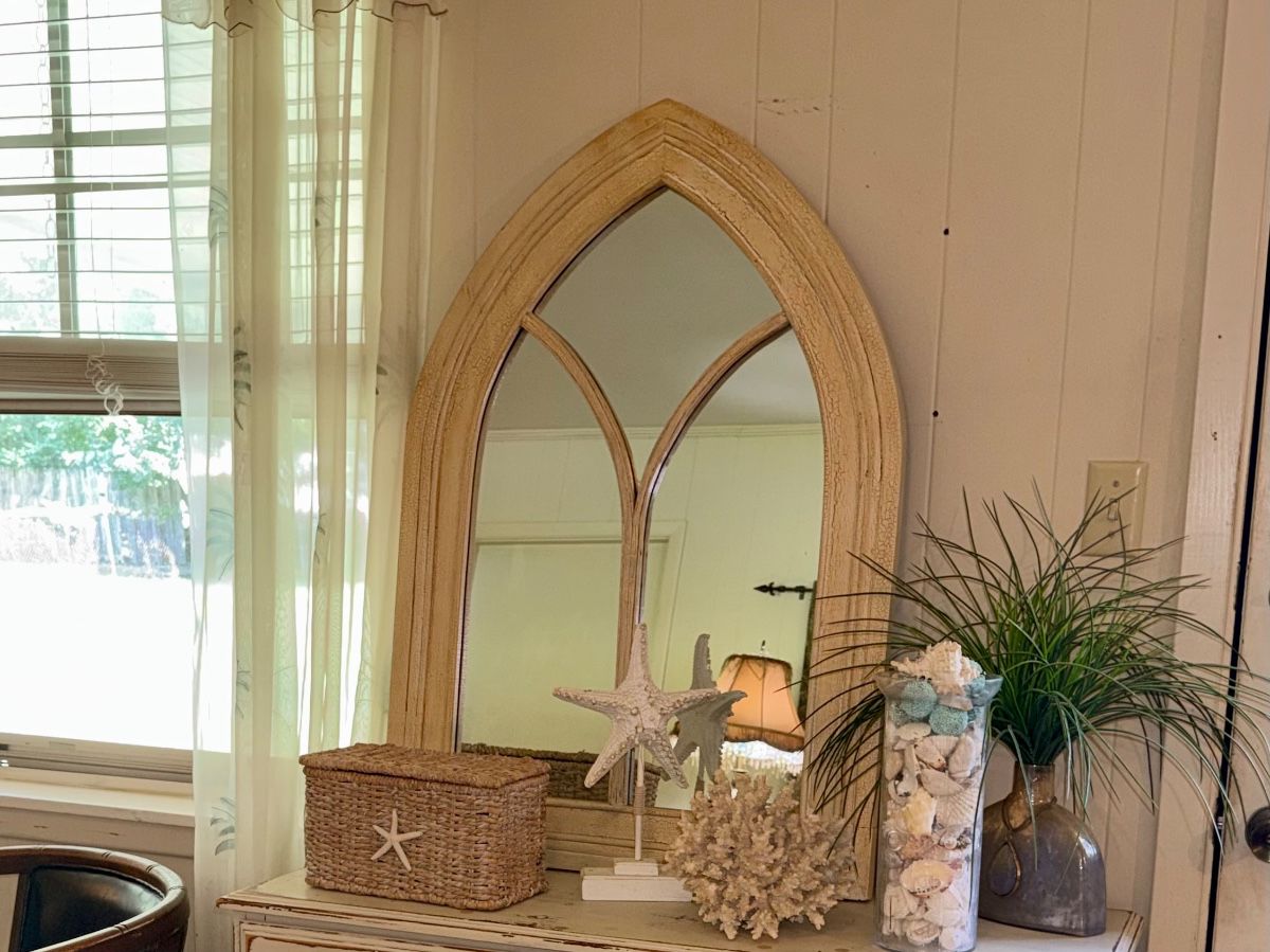 Arched mirror and coastal treasures