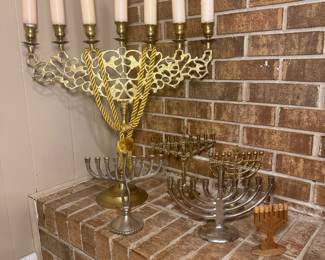 Large brass menorah along with smaller menorahs