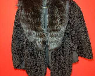 Persian lamb fur cape featuring a long, plush mink fur collar.  Classic Mid-Century Modern silhoutte.  Retailed through historic D.H. Holmes department store, on Canal Street in New Orleans