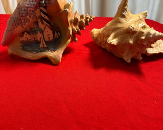 Lot 25: Painted lighthouse scene shell with natural conch shell