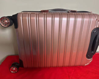 Lot 95: Rose Gold Hard Shell Rolling Suitcase