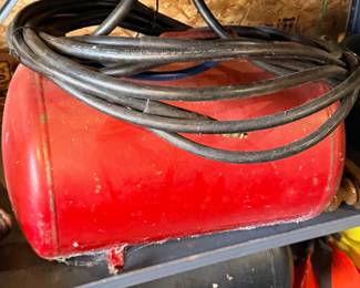 Red fuel tank with hose