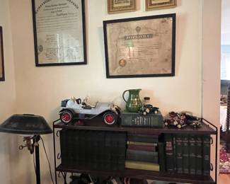 Old car bottles , early leather books , framed diplomas 