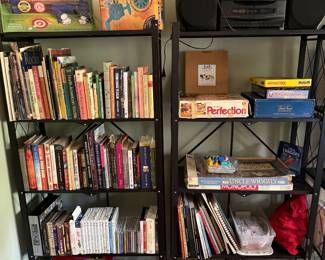 Two shelf units of books, board games, CDs, boxed toys and a JVC boombox