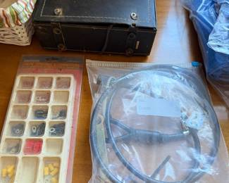 Black metal toolbox, a tray of wire connectors and a bagged battery cable
