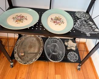Green floral chargers, silverplate platter, pressed glass relish dishes and a Christmas tree dish