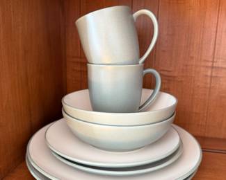 Modern stoneware place setting in grey and cream, mugs, bowl and plates