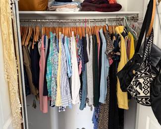 Closet of women's clothing with handbags and shoes