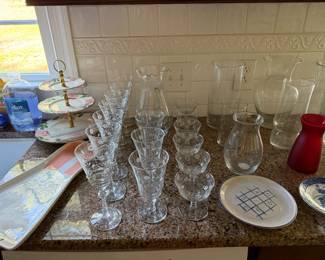 Etched crystal stemware set, a floral tiered server, hurricane vases and serving trays