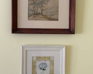 Framed landscape drawing in a dark wood frame and a small framed hydrangea print