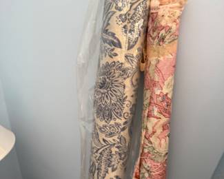 Two rolls of upholstery fabric, blue floral and pink floral tapestry