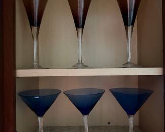 Three smoke glass trumpet flutes and three cobalt blue martini glasses