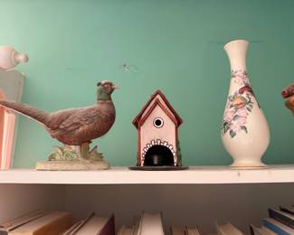 Porcelain pheasant figurine, a painted birdhouse and a floral bud vase