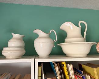 Three antique ironstone pitchers with wash basins