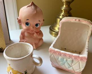 Kewpie style baby figurine, child's duckling mug and ceramic baby planter