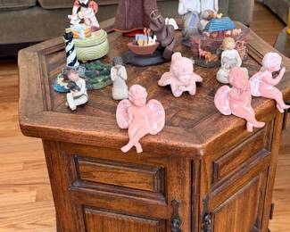 Hexagonal oak drum end table with a collection of cherub and figural figurines
