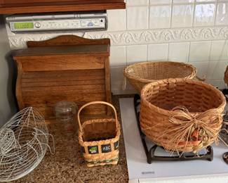 Oak roll top bread box, wire fruit basket, woven baskets and an under cabinet CD clock radio