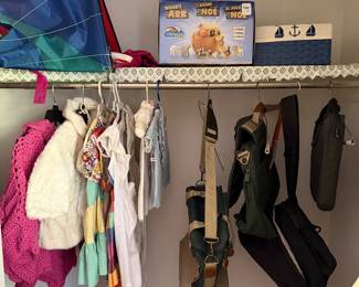 Closet of children's clothing with a kite, a Noah's Ark playset and backpacks