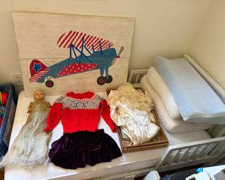 Hand painted biplane headboard, an antique doll in a christening gown and boxed vintage christening gowns