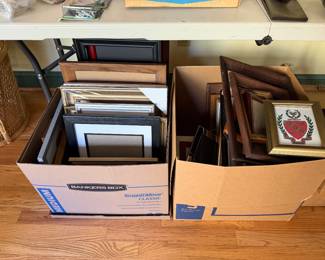 Two boxes of picture frames including a framed coat of arms