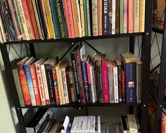 Bookshelf of art and nature reference books, North Carolina titles, novels and a row of CDs
