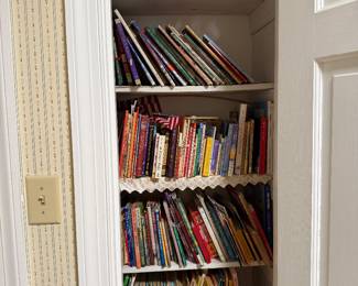 Closet shelves packed with children's picture books