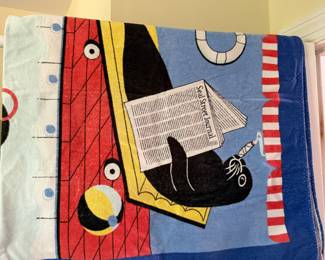 Beach towel with a seal reading the Seal Street Journal