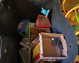 Tote of plastic playset buildings with a bead maze toy