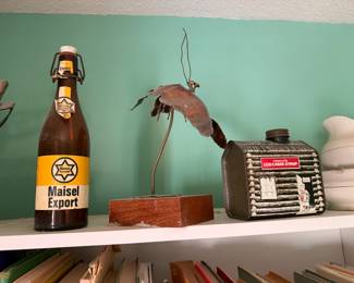Maisel Export swing top beer bottle, a metal sculpture and a Towle's Log Cabin Syrup tin