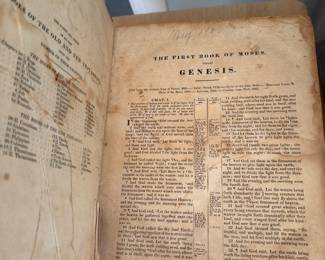 Antique family Bible open to Genesis with an early handwritten inscription