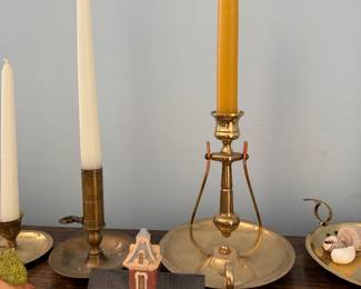 Brass chambersticks with tapers and miniature village houses