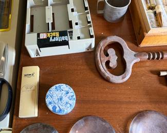 Battery rack organizer, aluminum measuring cup, a large decorative key and a blue and white trinket box