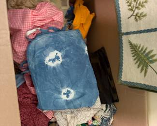 Box of linens including a shibori dyed piece, gingham and lace