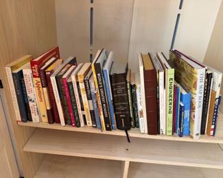 Shelf of hardcover and paperback books including cookbooks, history and reference titles