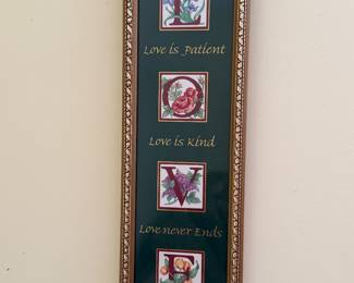 Tall framed illuminated letter print spelling LOVE with calligraphy verses